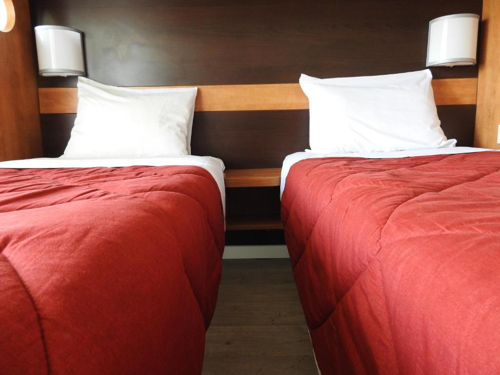 コンフラン・サントノリーヌにあるPremiere Classe Conflans-Sainte-Honorineのベッド2台が隣同士に設置された部屋です。