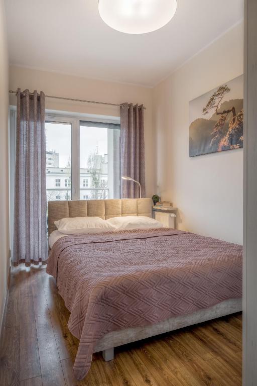 Posteľ alebo postele v izbe v ubytovaní Apartament G11 z miejscem parkingowym