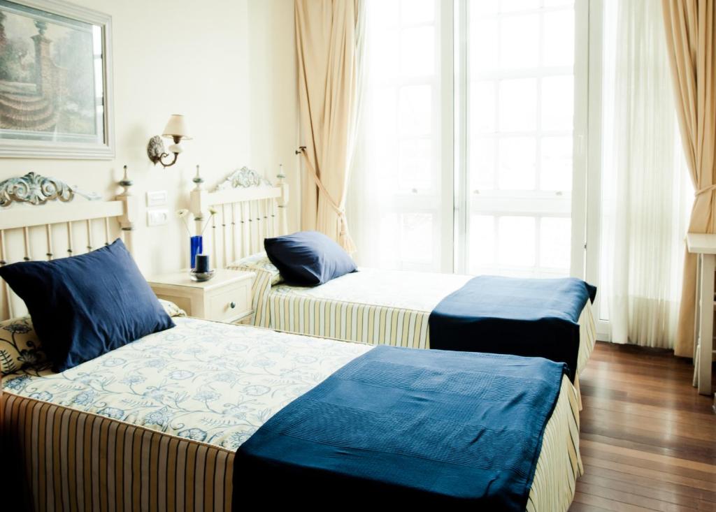 Postel nebo postele na pokoji v ubytování Hotel Fonte de San Roque