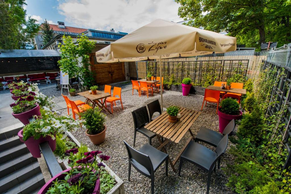 a patio with tables and chairs and an umbrella at Oki Doki OLD TOWN in Warsaw