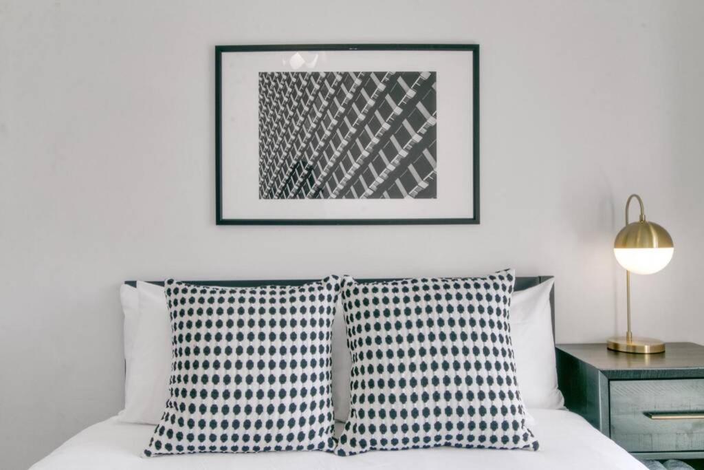 a bedroom with a bed with two pillows and a picture at West Loop 1BR Apartment with In-Unit Laundry - Lake 301 rep in Chicago