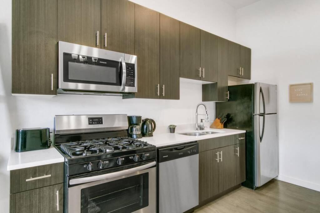 a kitchen with a stove and a microwave at West Loop 1BR Apartment with In-Unit Laundry - Lake 301 rep in Chicago