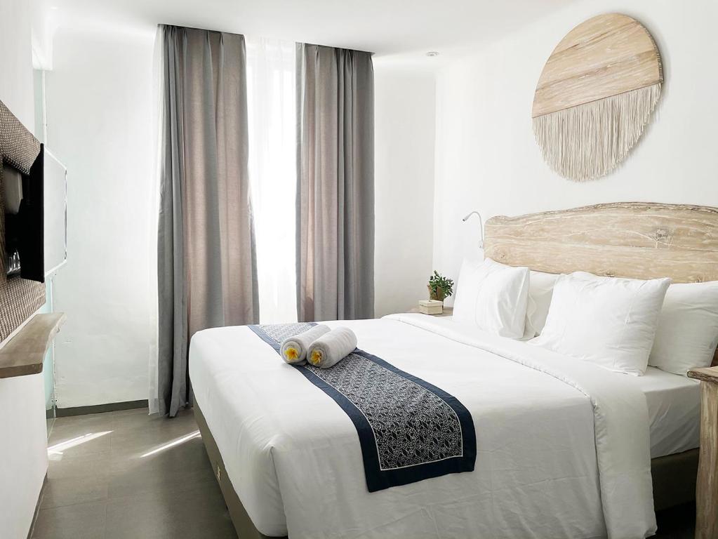 Postel nebo postele na pokoji v ubytování Khaiyyara Jimbaran Bali