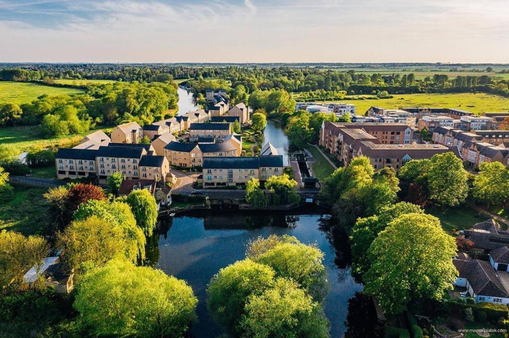 an aerial view of a town with a river at Rivermeadow View Apartment -27 Skipper Way in Saint Neots