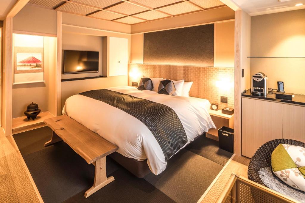 a hotel room with a bed and a desk at Nagi Kyoto Arashiyama in Kyoto
