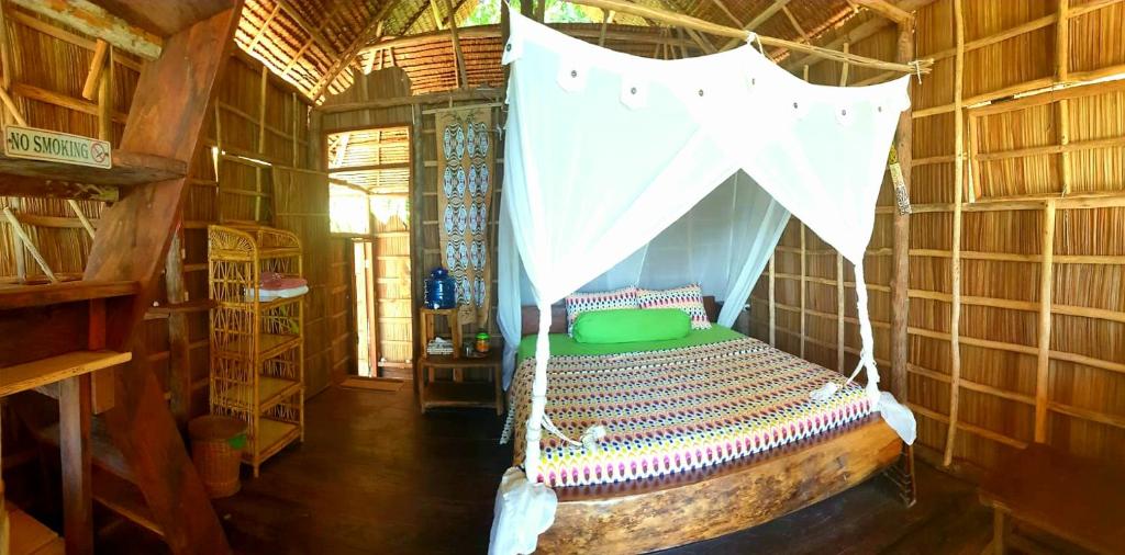 a bedroom with a bed in a bamboo house at Alter Native Stay in Tapokreng