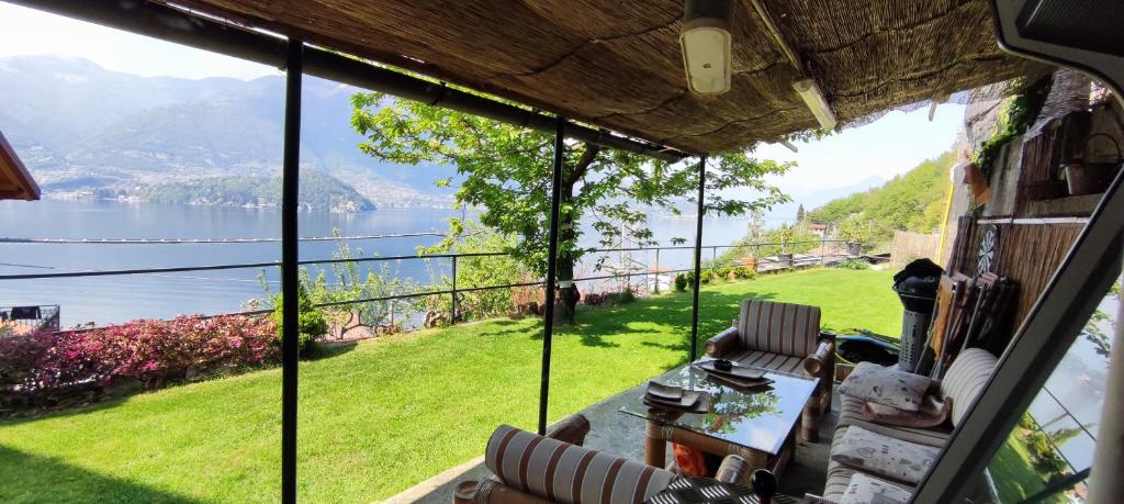 a room with a view of a lake from a house at Mella house garden relax in Lezzeno