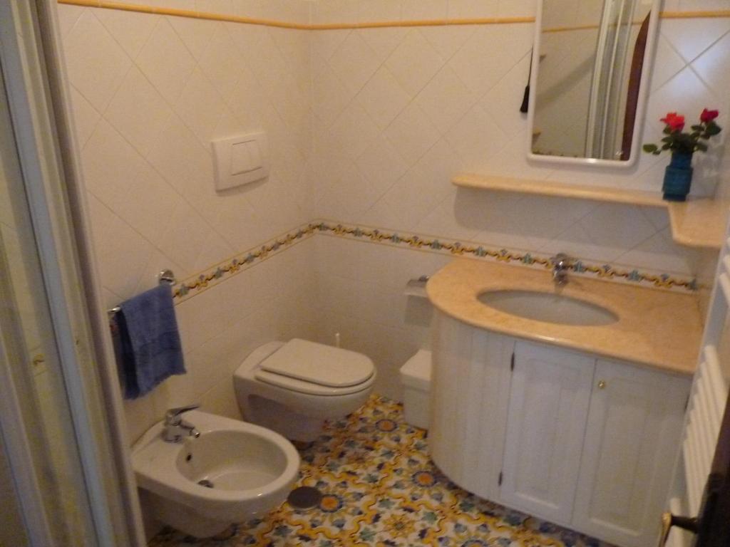 a small bathroom with a toilet and a sink at Casa Fortunata in Positano
