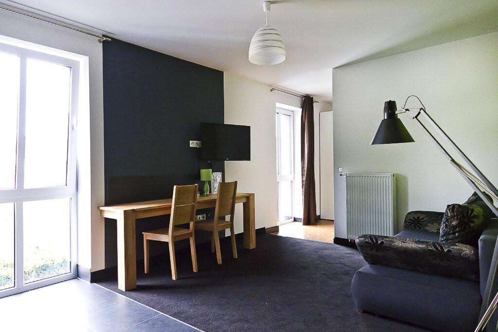 a living room with a table and a couch at 1,5 Zimmer City-Apartment-Bielefeld in Bielefeld