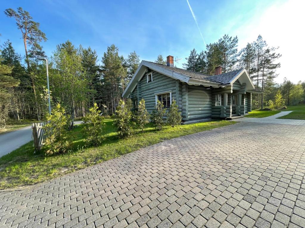 a house with a brick driveway in front of it at Kasepuu Holiday House in Uulu