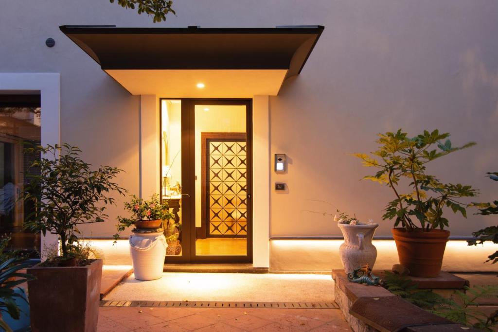 a front door of a house with potted plants at B&B Nicotera29 in Vico Equense