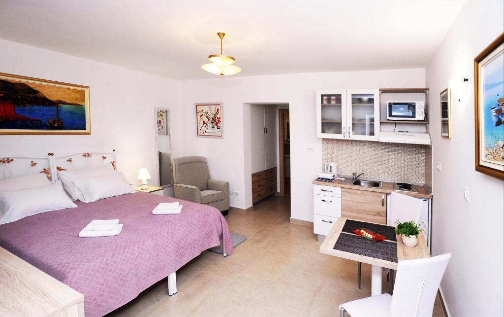a bedroom with a bed and a desk in a room at Nika Family Apartments in Dubrovnik