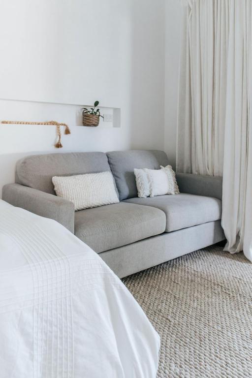 un soggiorno con divano e letto di Studio on Lewis Tiny House a Mudgee