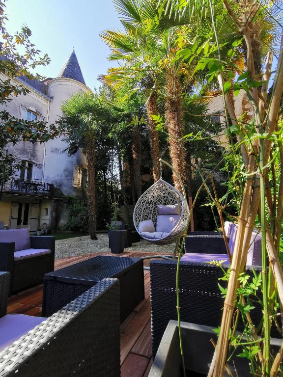 un patio extérieur avec des chaises et une balançoire dans l'établissement Le St Vincent, à Roquefort