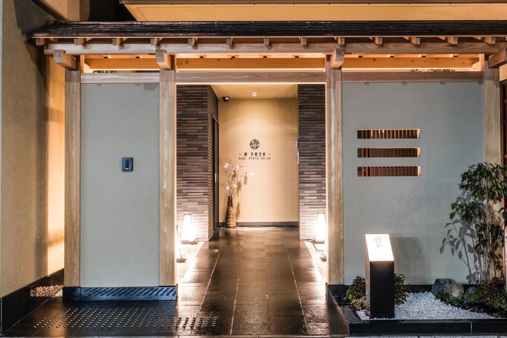 a hallway leading to a building with a entrance at Homm Stay Nagi Shijo Kyoto By Banyan Group in Kyoto