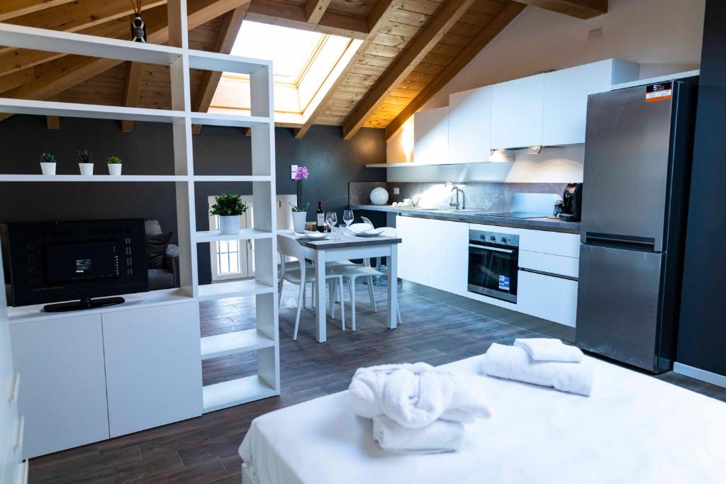 a kitchen with white cabinets and a black refrigerator at Ca del Trima in Melegnano