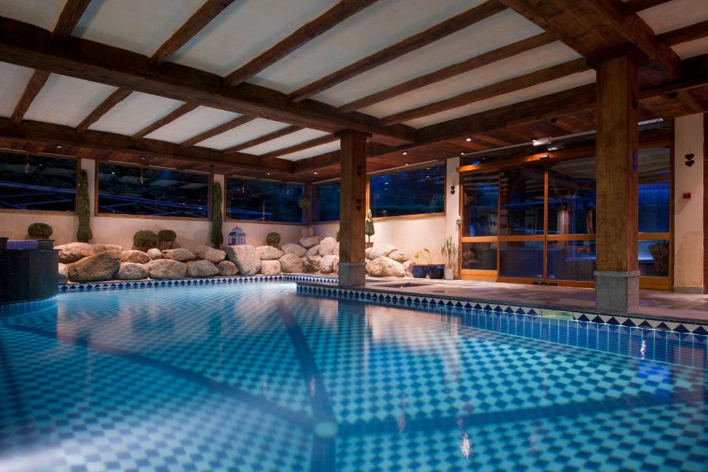 a large swimming pool in a building with at Les Grands Montets Hotel & Spa in Chamonix