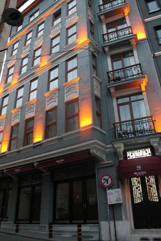 a tall building on a city street with lights at IQ Hotel Galatasaray in Istanbul