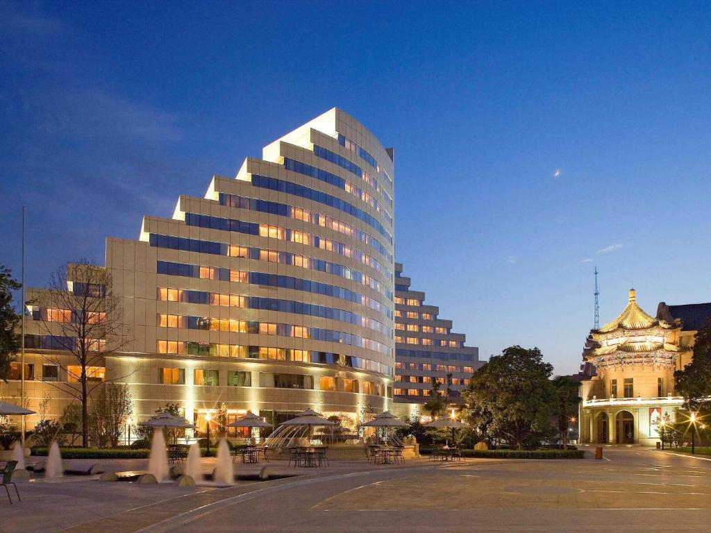 a large building in a city at night at Sofitel Xi'an On Renmin Square in Xi'an