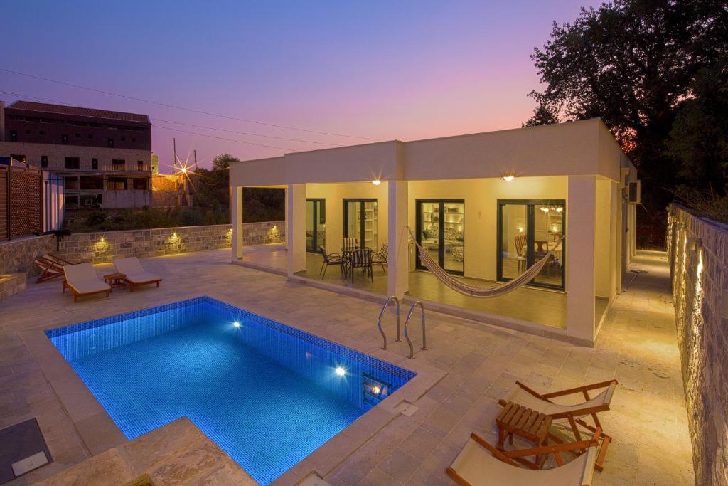 a villa with a swimming pool and a house at Villa Latina 2 in Budva