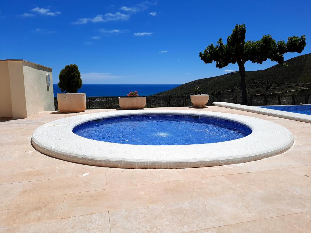 a large circular pool sitting on a patio at Casamuler in Peniscola