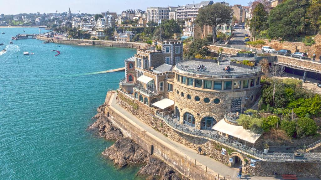 an aerial view of a building next to the water at Castelbrac Hotel & Spa in Dinard
