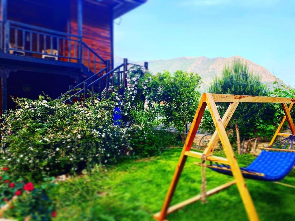 a blue chair sitting in the grass in a yard at 7 Green Adrasan in Adrasan