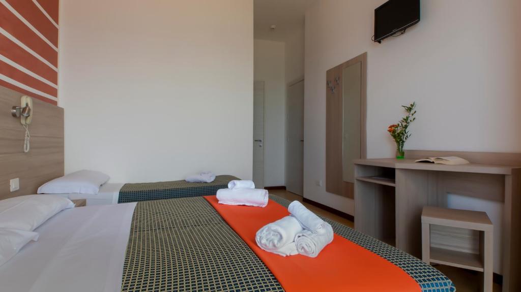 Postel nebo postele na pokoji v ubytování Hotel President's