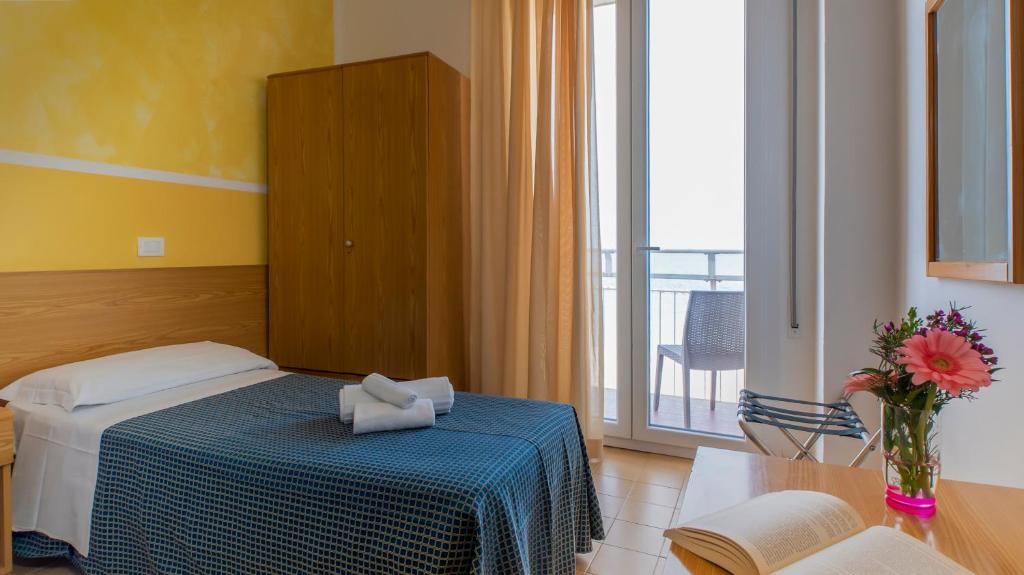 Postel nebo postele na pokoji v ubytování Hotel President's