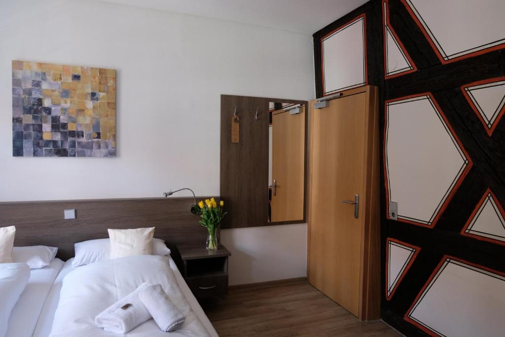 a bedroom with two beds with white sheets and a window at Gästehaus zur Sonne in Bad Wimpfen