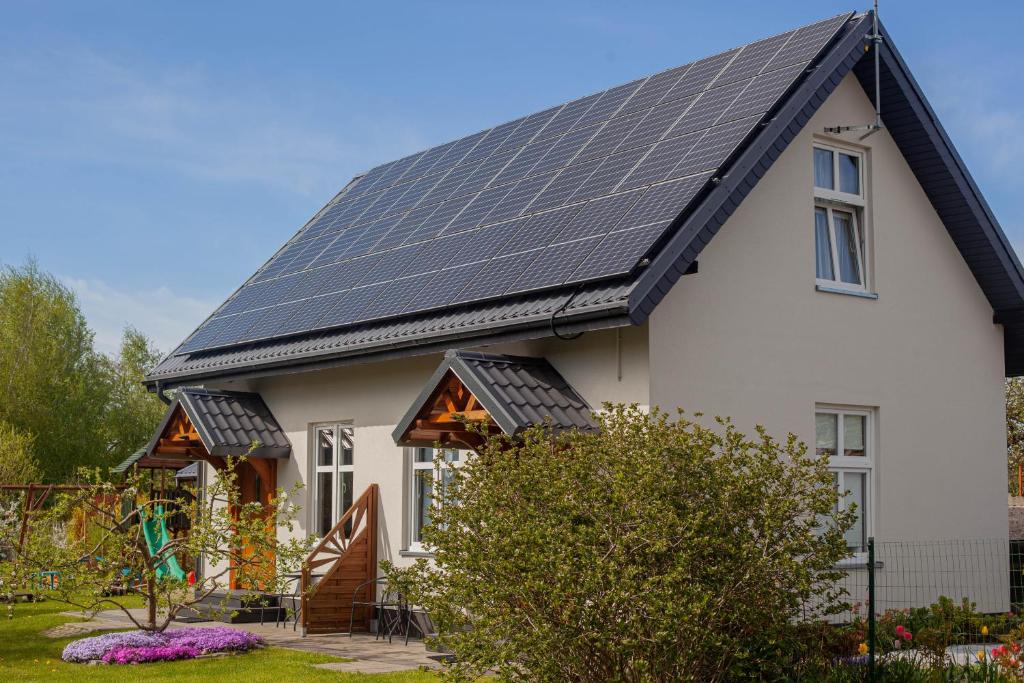 a house with solar panels on the roof at pod lipą in Ustka