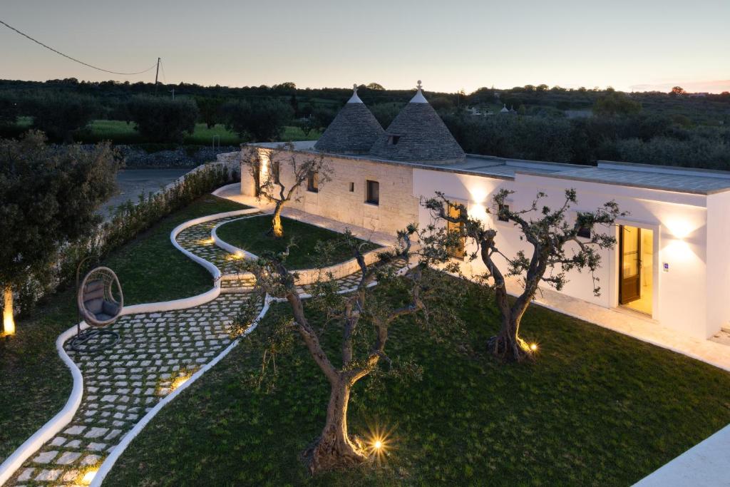 an image of a house with lights in the yard at Mandolario Trulli Resort in Martina Franca