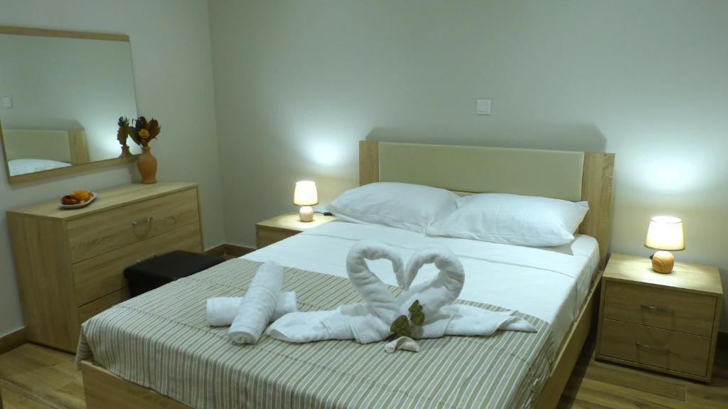 a bedroom with a bed with towels on it at Saroko Residence in Corfu Town