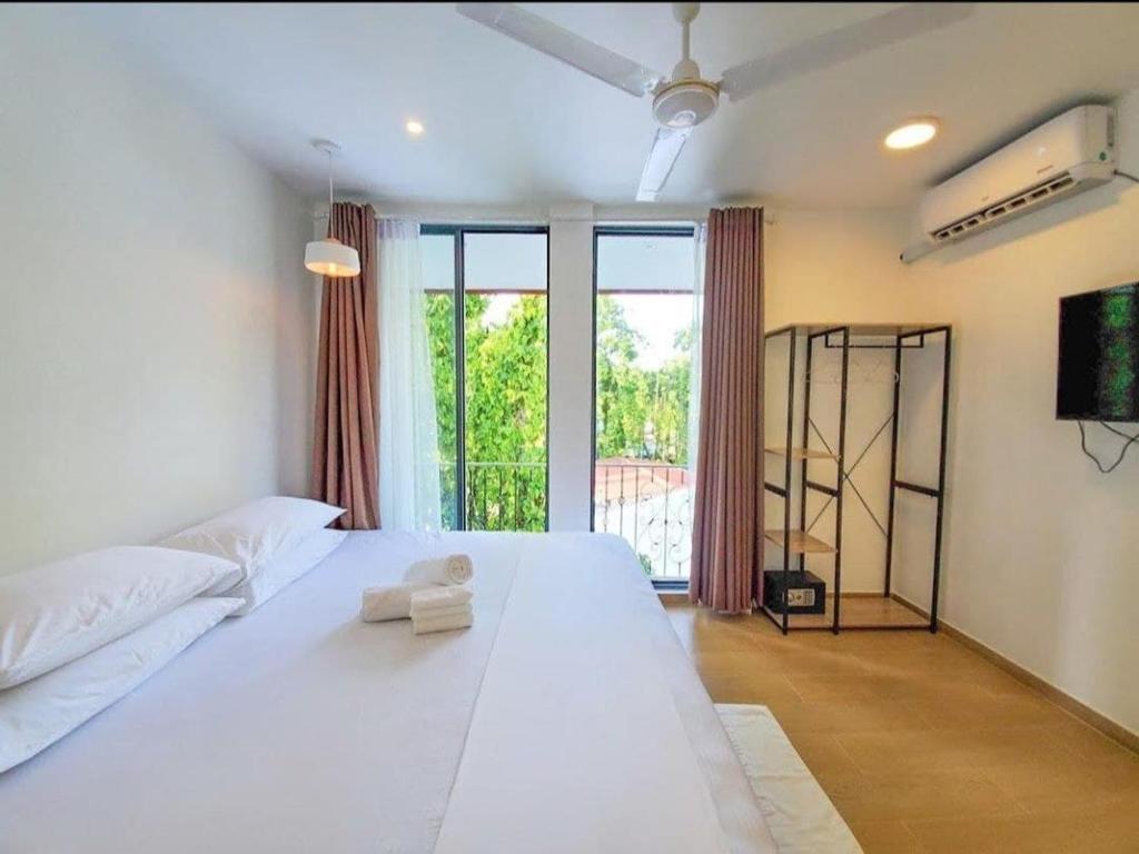 Postel nebo postele na pokoji v ubytování KingsWay Thoddoo Maldives