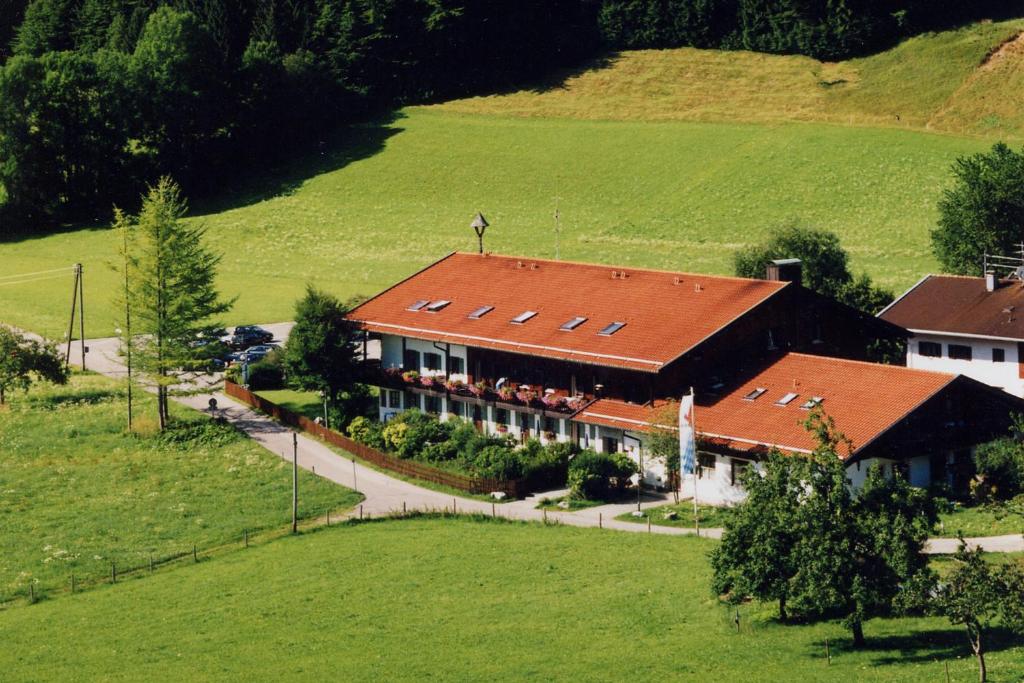 an aerial view of a house in a field at Gschwendtnerhof App8 Fuß in Aschau im Chiemgau