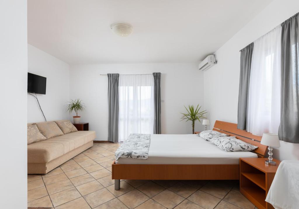 a living room with a bed and a couch at Apartments Bojić in Tivat