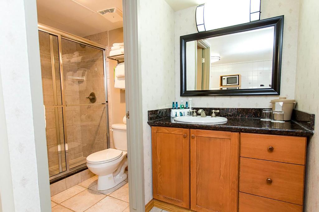 a bathroom with a sink and a toilet and a mirror at Charltons Banff in Banff