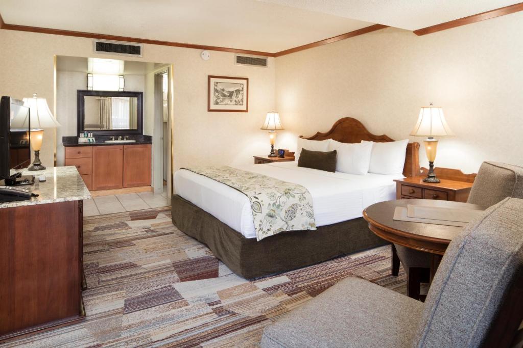 a hotel room with a bed and a television at Charltons Banff in Banff