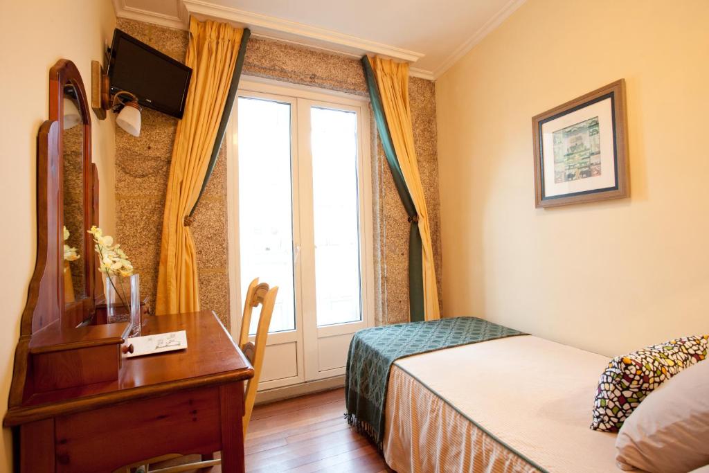 Postel nebo postele na pokoji v ubytování Hotel Fonte de San Roque