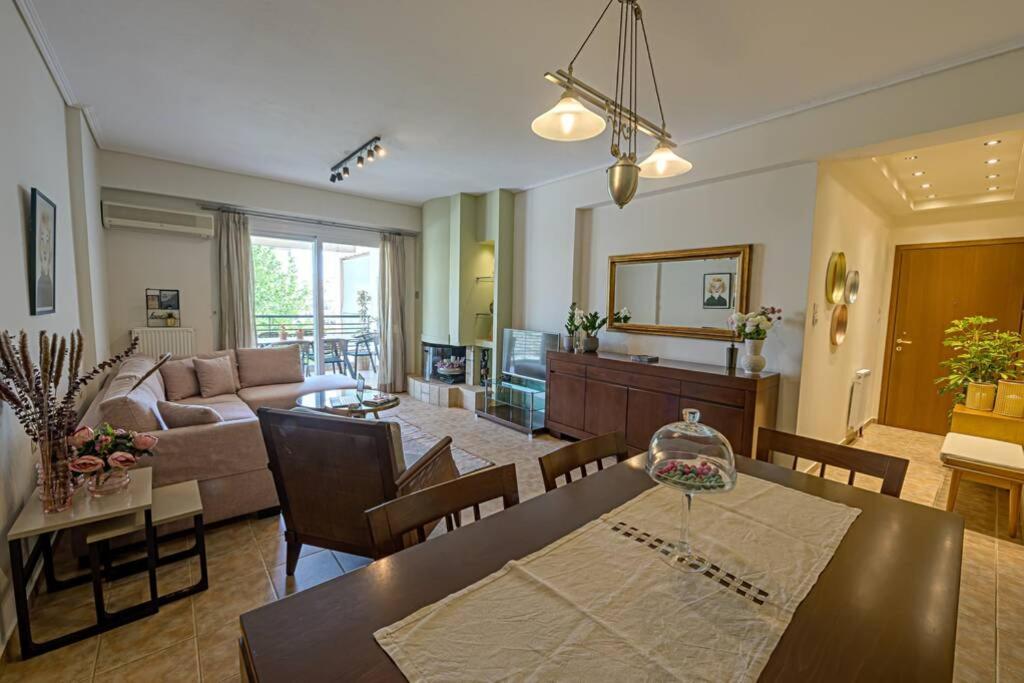 een woonkamer met een tafel en een eetkamer bij Karamba boutique living - ECO Riverside Appartment in Volos