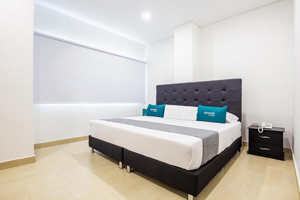 Postel nebo postele na pokoji v ubytování Ayenda Hotel Trinidad