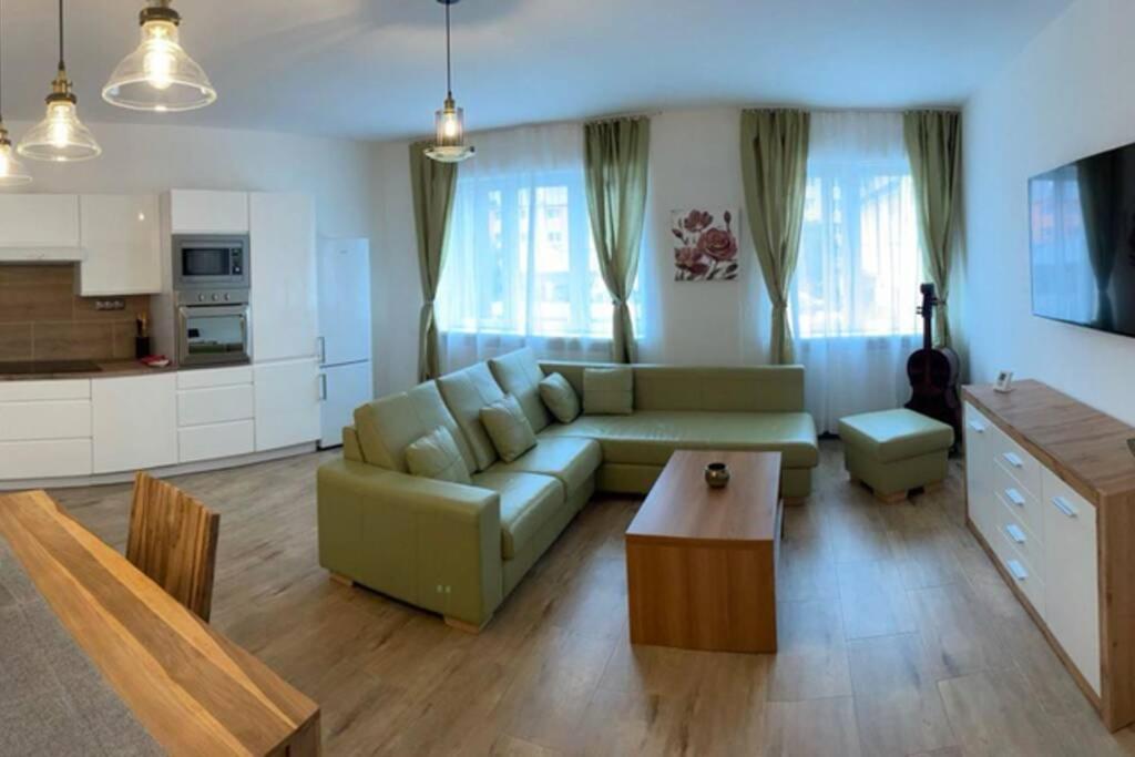 a living room with a couch and a table at Newly renovated 2 rooms apartment downtown Nitra in Nitra