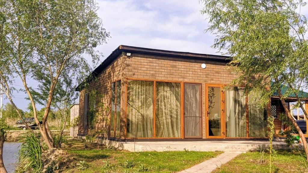 a small brick house with large glass windows at Kambodzha na Dynae in Vylkove