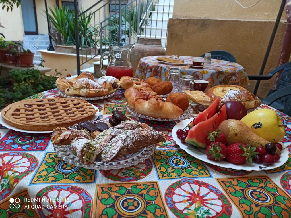 a table topped with lots of different types of food at B&B Il Melograno Antico con Terrazza e Giardino in Agrigento