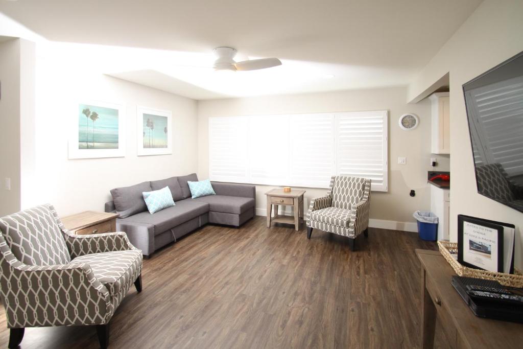 a living room with a couch and two chairs at 1202 South Pacific in Oceanside