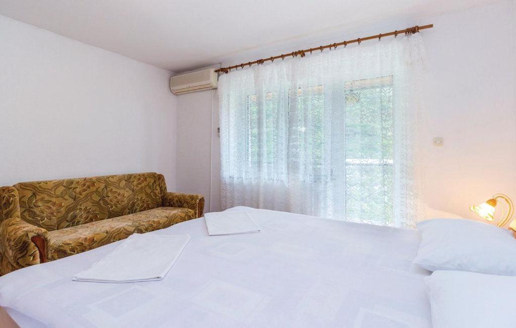 Postel nebo postele na pokoji v ubytování Apartments Vukelic