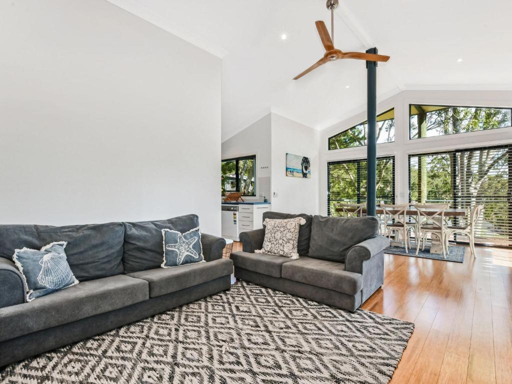 a living room with two couches and a rug at Paws and Relax in Elizabeth Beach