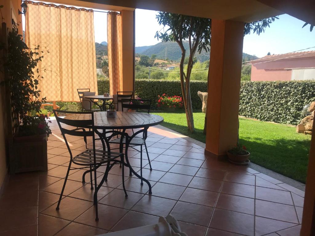 a patio with a table and chairs on a porch at B&B Da Sabrina in San Teodoro