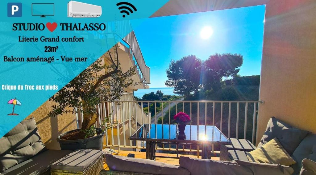 a person sitting on a table on a balcony at Studio *** "ThalaBanyuls" - Vue mer - Balcon in Banyuls-sur-Mer