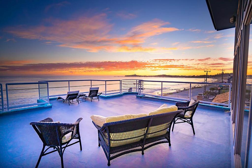 a balcony with chairs and a couch on a ship at Luxury Beachfront Penthouse Walk to the Beach Restaurants Entertainment in Half Moon Bay